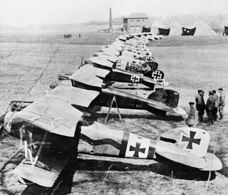 German Albatros D.IIIs of Jagdstaffel 11 and Jagdstaffel 4 parked in a line at La Brayelle near Douai, France. Richthofen’s aircraft is the second aircraft in line, painted red. (Imperial War Museum)